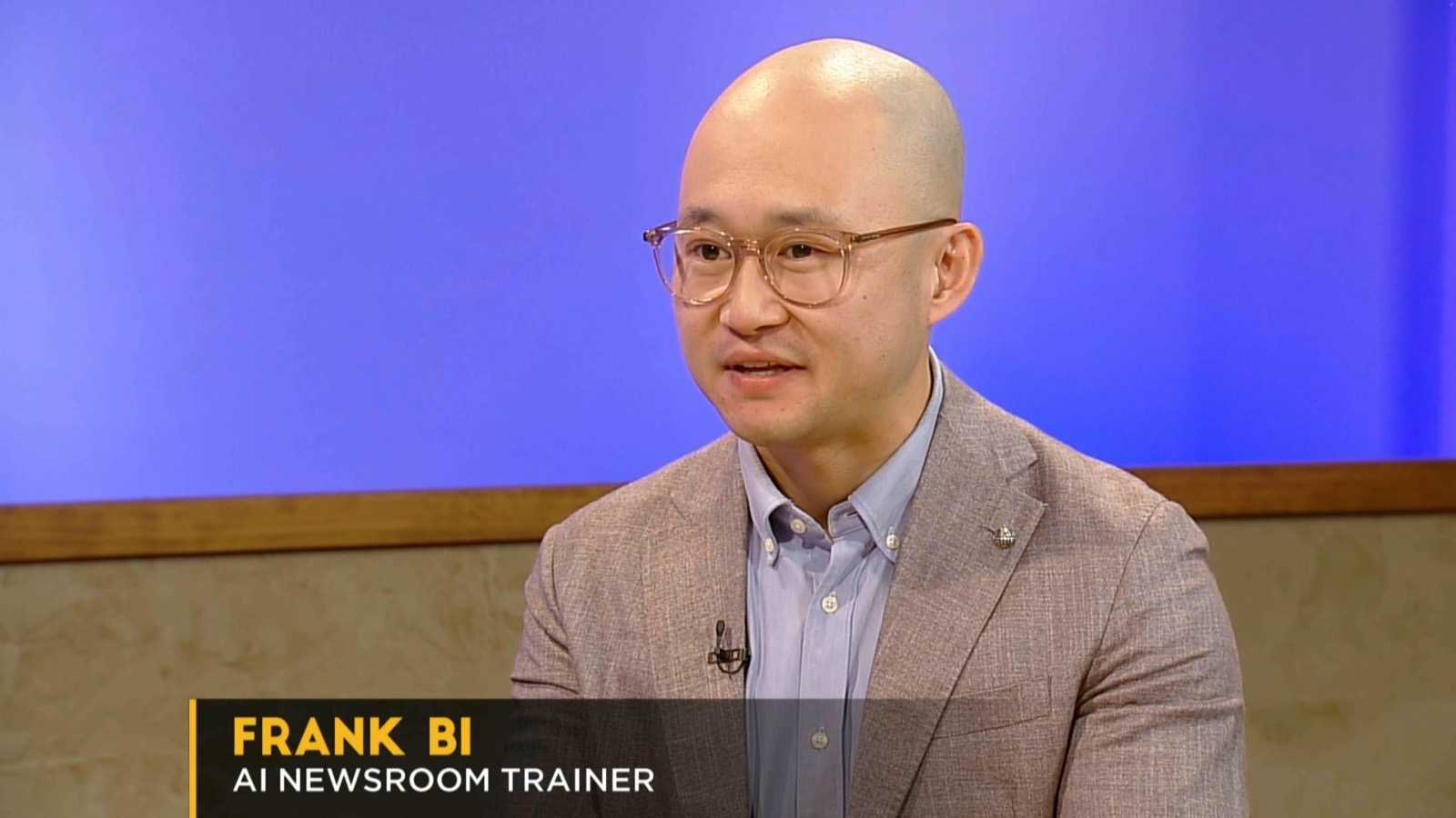 Frank Bi on television as an AI newsroom trainer